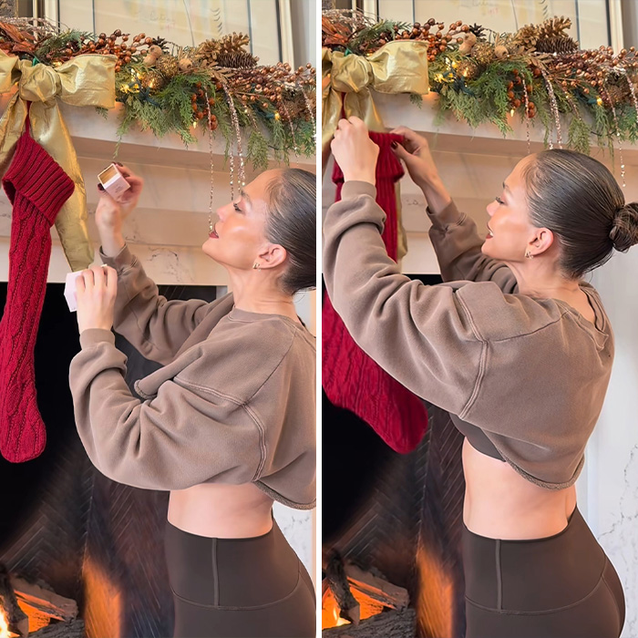 Jennifer Lopez hanging a Christmas stocking by a decorated fireplace in a festive holiday setting. Jennifer Lopez hanging a Christmas stocking by a decorated fireplace in a festive holiday setting.