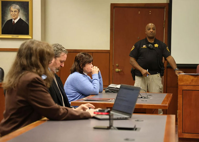 People sitting in a courtroom with a sheriff standing, related to child kidnapped from Kentucky found alive after decades. People sitting in a courtroom with a sheriff standing, related to child kidnapped from Kentucky found alive after decades.