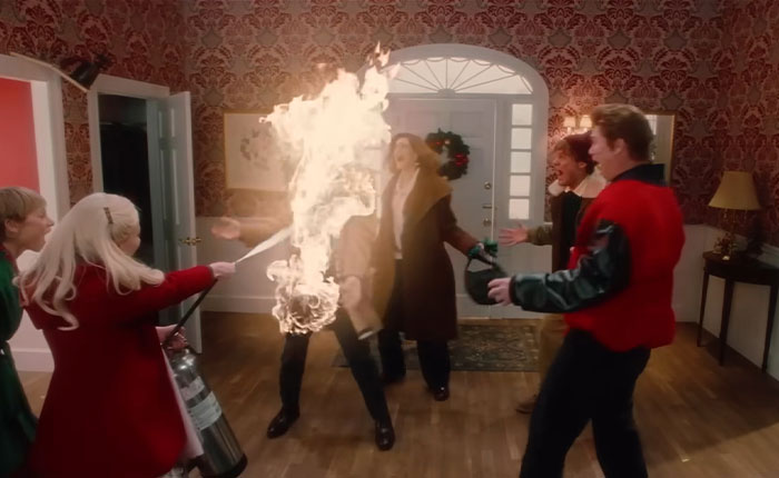 Ariana Grande in SNL Home Alone parody scene using fire extinguisher during chaotic and bloody twist moment indoors. Ariana Grande in SNL Home Alone parody scene using fire extinguisher during chaotic and bloody twist moment indoors.