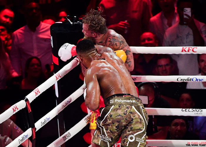Boxer landing a punch during a match, highlighting Jake Paul’s broken jaw as the latest internet punchline in boxing. Boxer landing a punch during a match, highlighting Jake Paul’s broken jaw as the latest internet punchline in boxing.