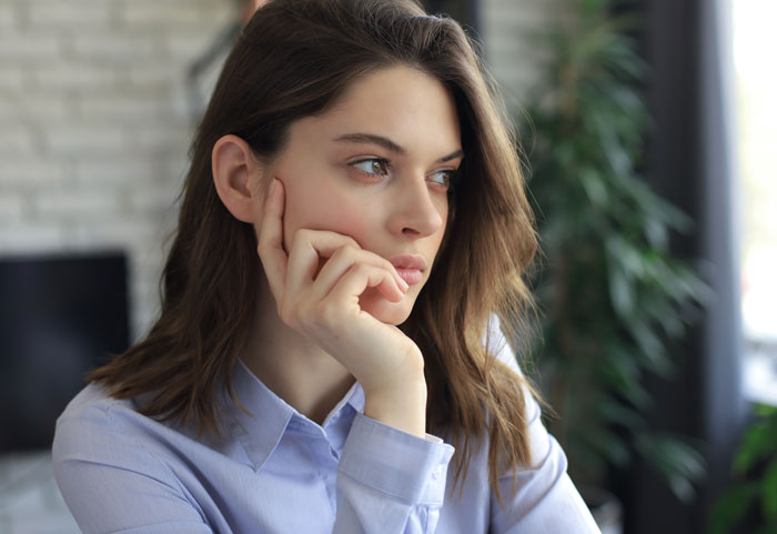 Woman looking thoughtful and concerned indoors, reflecting on boys nights at their house going too far. Woman looking thoughtful and concerned indoors, reflecting on boys nights at their house going too far.