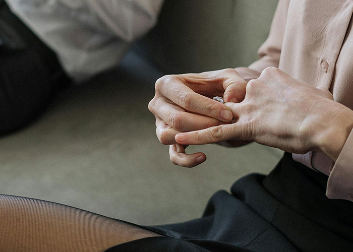Person nervously removing a ring, illustrating wild stories about the most insane thing their ex ever did.