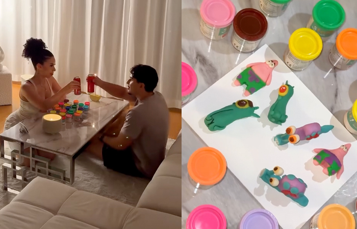 Couple enjoying at-home date night, crafting colorful clay figures surrounded by paint jars on a marble table.