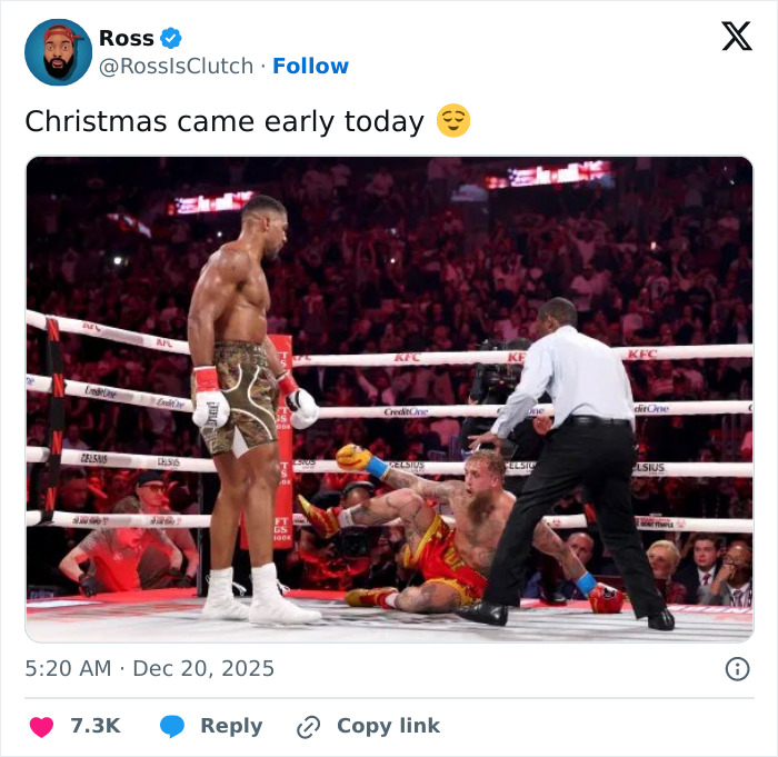 Boxer standing victorious while Jake Paul lies on the mat after a knockout, highlighting Jake Paul's broken jaw. Boxer standing victorious while Jake Paul lies on the mat after a knockout, highlighting Jake Paul's broken jaw.