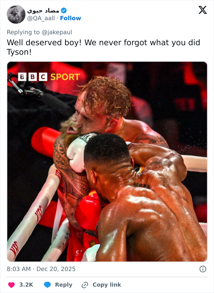 Two boxers in a close fight moment during a match, highlighting Jake Paul's broken jaw in the intense boxing scene.