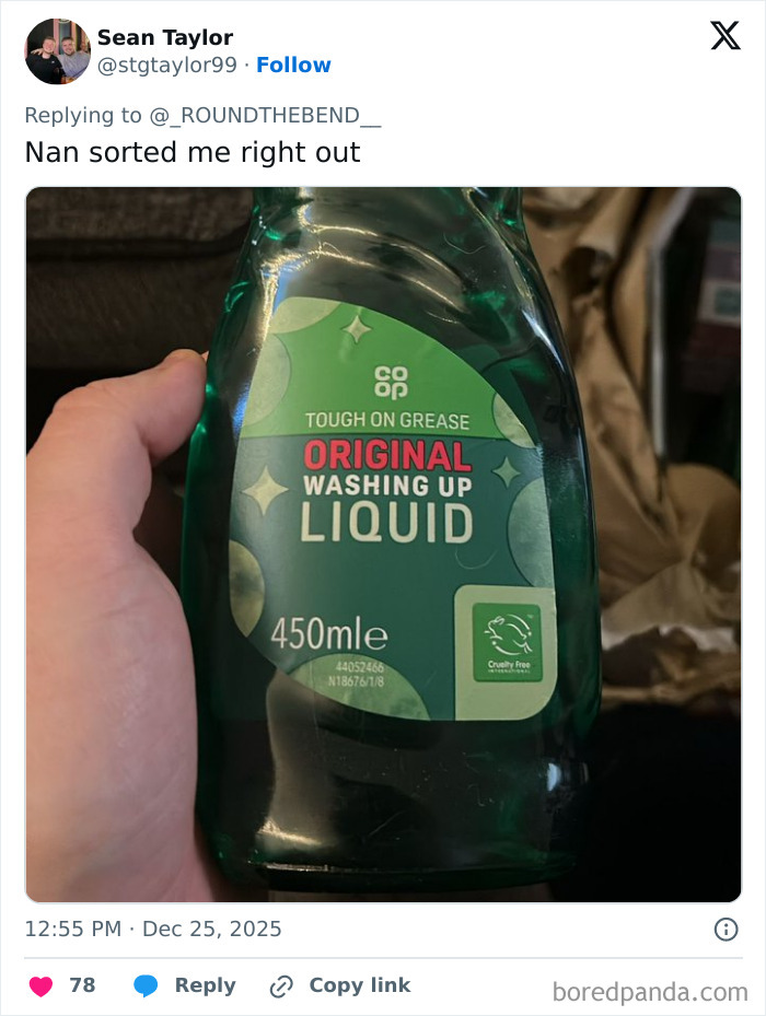 Hand holding a bottle of washing up liquid, one of the worst Xmas presents people received this holiday season.