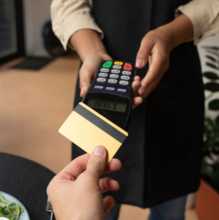 Person using credit card on payment terminal held by waiter, representing brother makes bill pay dinner scenario. Person using credit card on payment terminal held by waiter, representing brother makes bill pay dinner scenario.