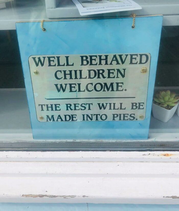 Humorous sign saying well behaved children welcome, rest made into pies, a funny meme for dark and cold winter days.