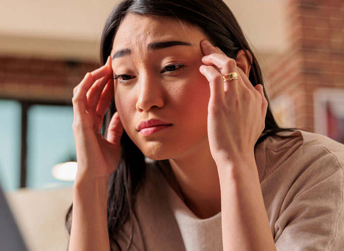 Young woman looking stressed and frustrated while dealing with brother makes bil pay dinner situation indoors. Young woman looking stressed and frustrated while dealing with brother makes bil pay dinner situation indoors.