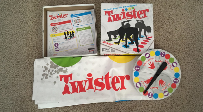 Twister party game set with spinner, colorful mat, and box displaying players in classic poses for best party game.