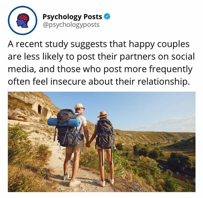 Couple hiking outdoors holding hands with backpacks, illustrating fun and fascinating psychology facts on relationships.