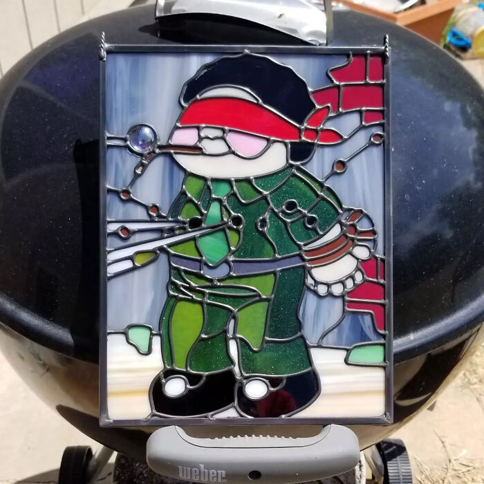 Stained glass art depicting a colorful pop culture icon character in vibrant colors and detailed design.