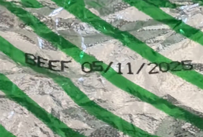 Close-up of an Air Canada passenger meal package showing beef with an expiration date, highlighting airline meal concerns. Close-up of an Air Canada passenger meal package showing beef with an expiration date, highlighting airline meal concerns.