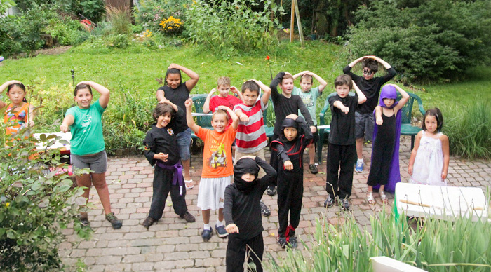 Group of children playing outdoors in costumes, enjoying the best party game with active and playful expressions.