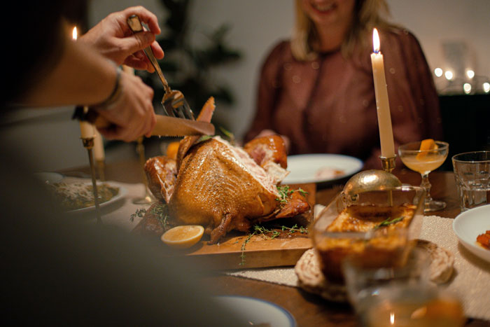Family dinner scene with husband carving turkey while woman watches, highlighting picky eater and allergies concerns. Family dinner scene with husband carving turkey while woman watches, highlighting picky eater and allergies concerns.