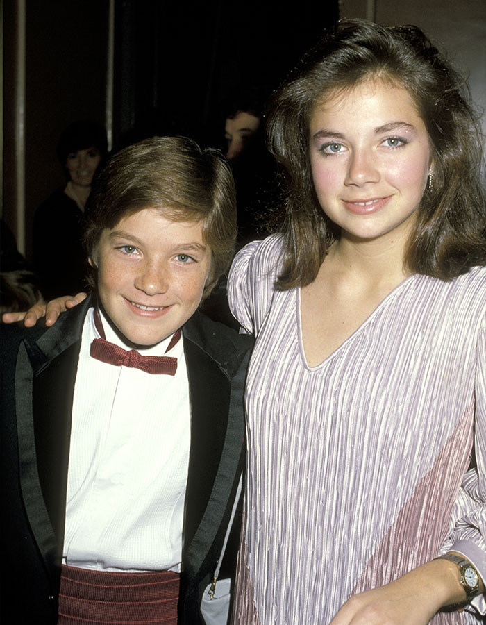 Young Jason Bateman and sister Justine smiling at a formal event, dressed in classic 1980s attire. Young Jason Bateman and sister Justine smiling at a formal event, dressed in classic 1980s attire.