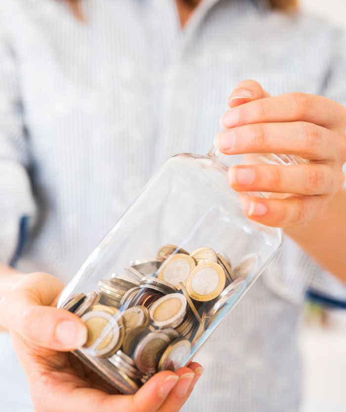 Person holding a glass jar filled with coins, symbolizing people start to question if they really saw these things.