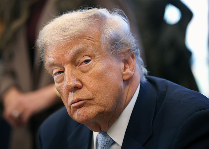 Donald Trump in a serious expression, wearing a suit and tie, amid controversy over post involving Rob Reiner and TDS. Donald Trump in a serious expression, wearing a suit and tie, amid controversy over post involving Rob Reiner and TDS.
