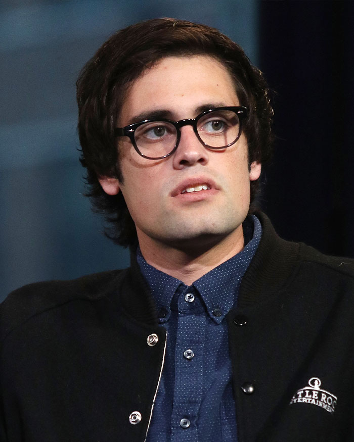 Man wearing glasses and a black jacket in a close-up portrait related to Rob Reiner and son Nick fight incident.