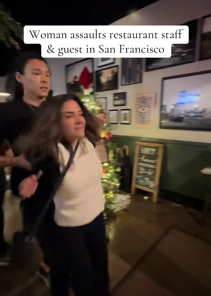 Woman involved in drunken rampage at upscale restaurant being restrained inside a decorated dining area at night. Woman involved in drunken rampage at upscale restaurant being restrained inside a decorated dining area at night.