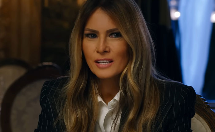 Melania Trump speaking in a pinstripe blazer and white shirt, featured in new documentary reactions discussion. Melania Trump speaking in a pinstripe blazer and white shirt, featured in new documentary reactions discussion.