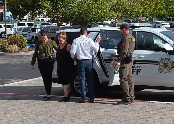 Woman being escorted by law enforcement officers near a sheriff’s vehicle after being charged in 5-year-old daughter’s slaying. Woman being escorted by law enforcement officers near a sheriff’s vehicle after being charged in 5-year-old daughter’s slaying.