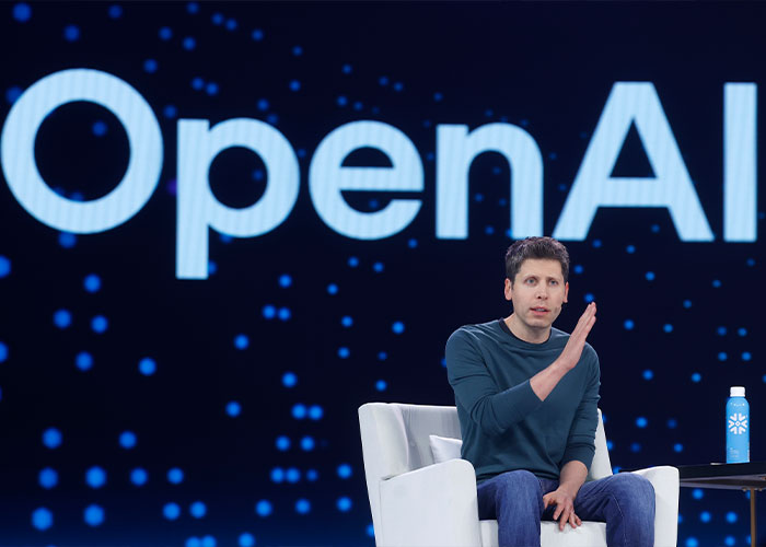 Person speaking on stage with OpenAI logo in background, highlighting ChatGPT controversy after teenager's tragic outcome. Person speaking on stage with OpenAI logo in background, highlighting ChatGPT controversy after teenager's tragic outcome.