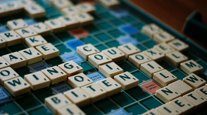 Scrabble tiles arranged on a board spelling words, illustrating a popular party game enjoyed by many players.