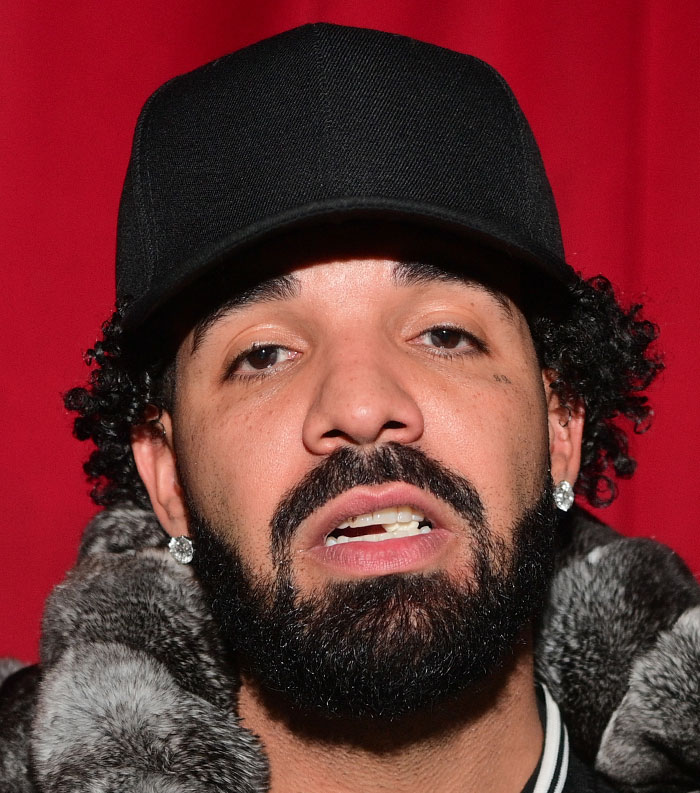 Close-up of a male celebrity wearing a black cap and fur coat, featured among most disliked celebrities of 2025.