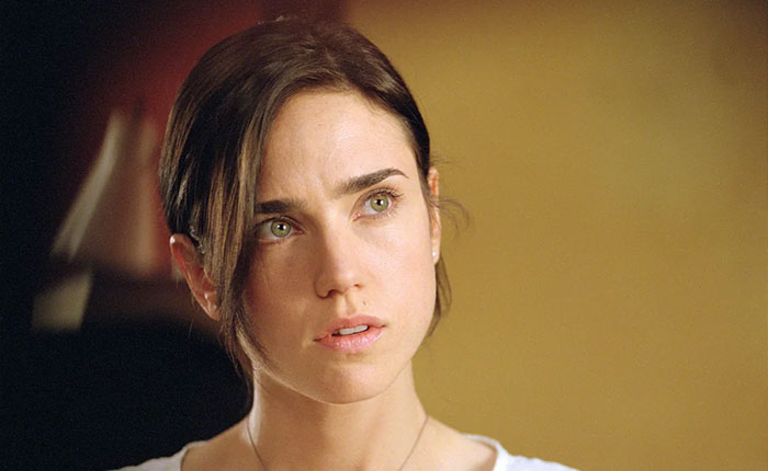 Jennifer Connelly in a close-up, reflecting on her iconic movie scene and career regrets in a softly lit setting. Jennifer Connelly in a close-up, reflecting on her iconic movie scene and career regrets in a softly lit setting.