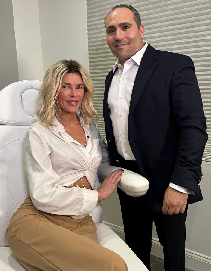 Brandi Glanville with a doctor in a clinical setting after receiving diagnosis for facial disfigurement condition. Brandi Glanville with a doctor in a clinical setting after receiving diagnosis for facial disfigurement condition.
