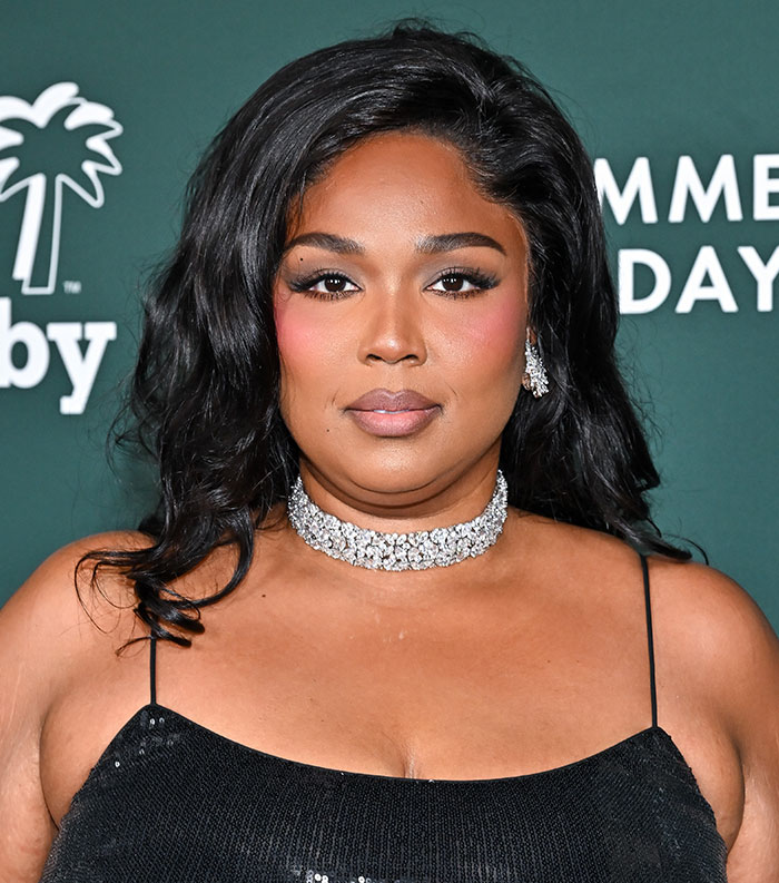Woman in a black dress and diamond necklace at a formal event, representing most disliked celebrities of 2025.