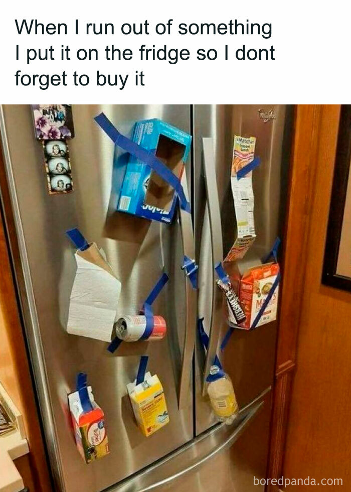 Stainless steel dude fridge covered with grocery items taped to the doors as reminders to buy them later.
