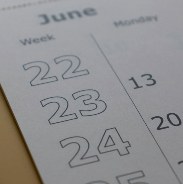 Close-up of June calendar dates 22, 23, and 24 showing week numbers and days in a minimalist design.