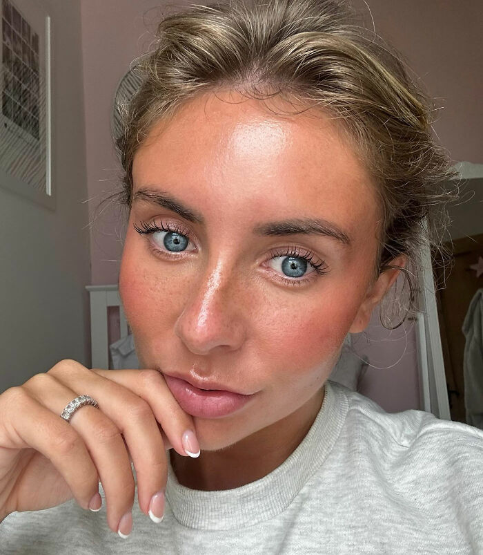 Close-up of Bonnie Blue with blue eyes and natural makeup, contemplating her fate after controversial video arrest. Close-up of Bonnie Blue with blue eyes and natural makeup, contemplating her fate after controversial video arrest.