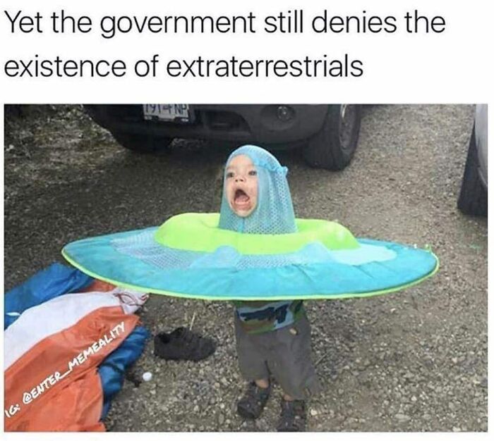 Child wearing a UFO costume with a surprised face, illustrating relatable memes for parents going through challenging moments.