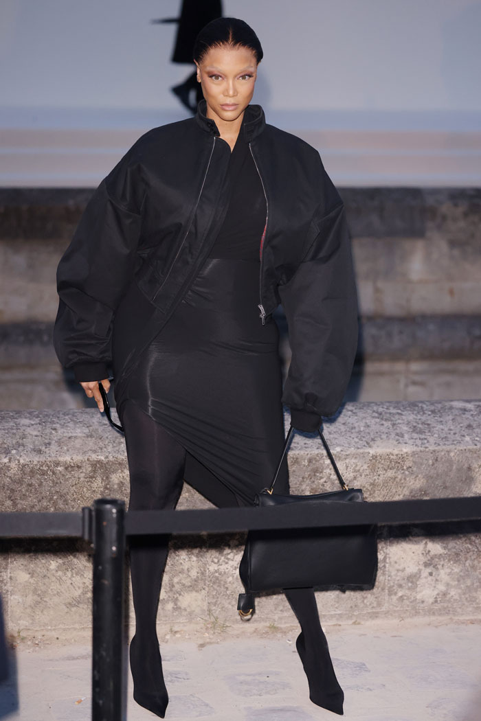 Luxury celebrity fashion disaster outfit 2025 featuring oversized black jacket and asymmetrical dress on runway.