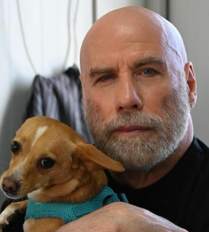 Bald man with beard holding small dog, illustrating bombshell court docs revealing Riley Keough as biological mother of John Travolta’s son Ben. Bald man with beard holding small dog, illustrating bombshell court docs revealing Riley Keough as biological mother of John Travolta’s son Ben.