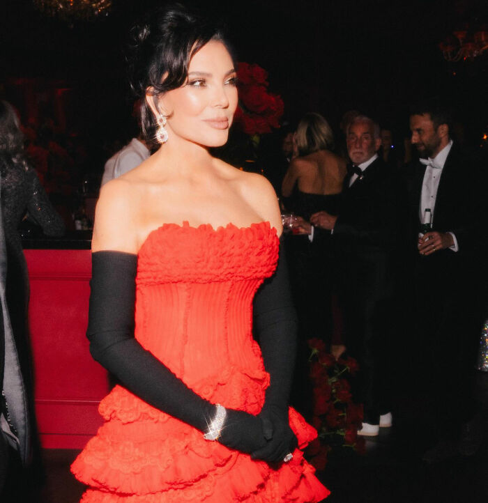 Kris Jenner in a red gown and black gloves at a formal event, highlighting her hands after viral facelift news. Kris Jenner in a red gown and black gloves at a formal event, highlighting her hands after viral facelift news.