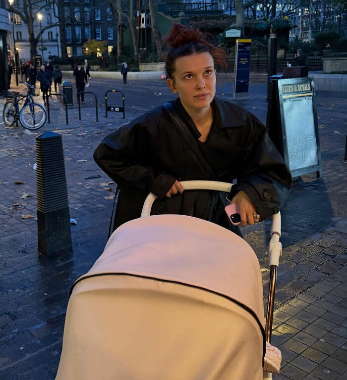 Millie Bobby Brown pushing a stroller outdoors at dusk, sparking viral theory about her newborn daughter after new pics. Millie Bobby Brown pushing a stroller outdoors at dusk, sparking viral theory about her newborn daughter after new pics.