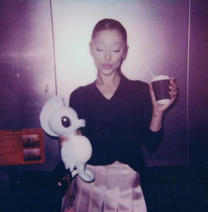 Ariana Grande holding a stuffed animal and a cup, highlighting family member revealing singer struggles and not in a healthy place. Ariana Grande holding a stuffed animal and a cup, highlighting family member revealing singer struggles and not in a healthy place.
