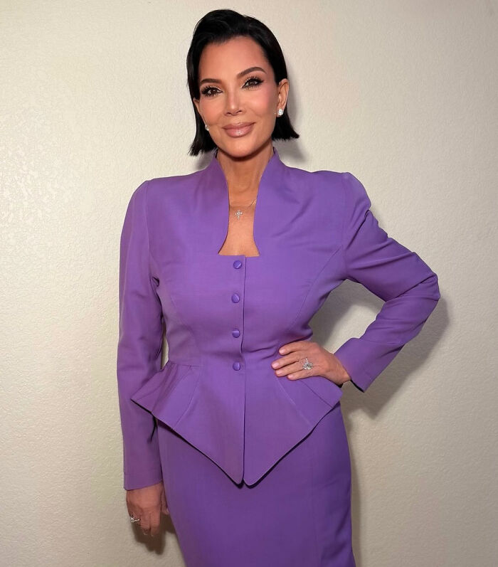 Kris Jenner standing confidently in a purple outfit showing her hands after viral $100k facelift reveal. Kris Jenner standing confidently in a purple outfit showing her hands after viral $100k facelift reveal.