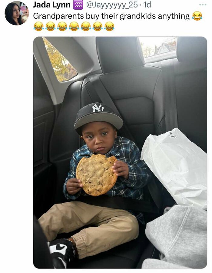 Young boy in car seat holding a large cookie, featured in cheerful memes about wasting time online.
