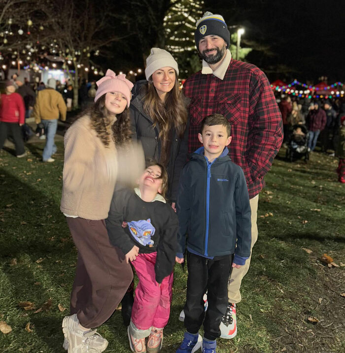 Family posing outdoors at night during Christmas event, related to influencer's daughter passing away tragedy. Family posing outdoors at night during Christmas event, related to influencer's daughter passing away tragedy.
