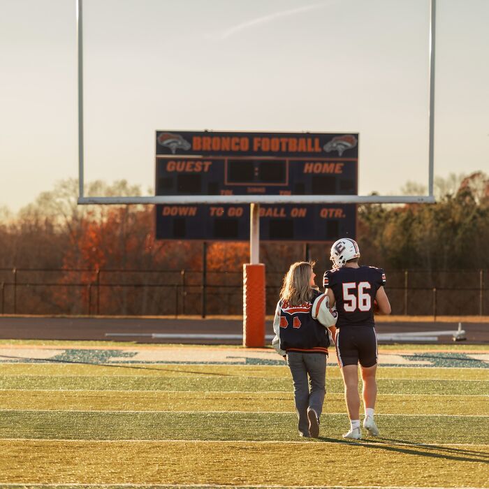 Mother and son walking on football field during photoshoot sparking viral parenting debate about dating own son. Mother and son walking on football field during photoshoot sparking viral parenting debate about dating own son.