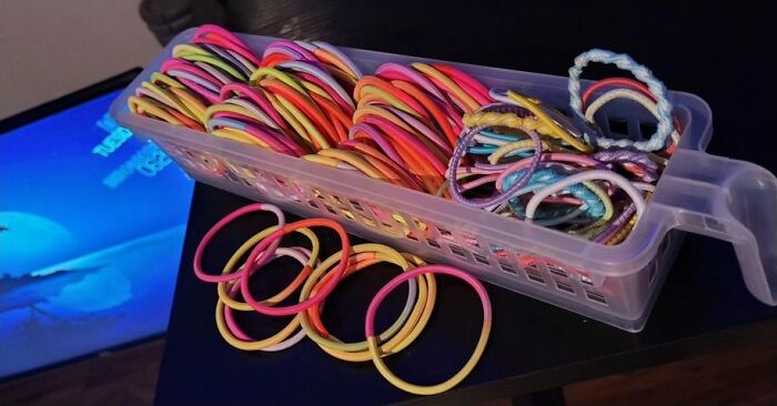 Colorful hair ties organized in a plastic container, representing men's insights about women from serious relationships.
