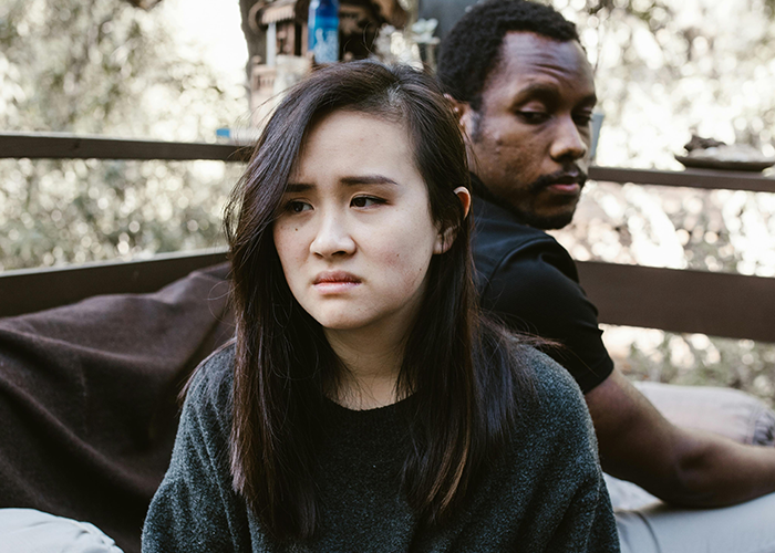 Woman and man sitting apart looking upset, illustrating a toxic mother-in-law causing tension during casual Christmas. Woman and man sitting apart looking upset, illustrating a toxic mother-in-law causing tension during casual Christmas.