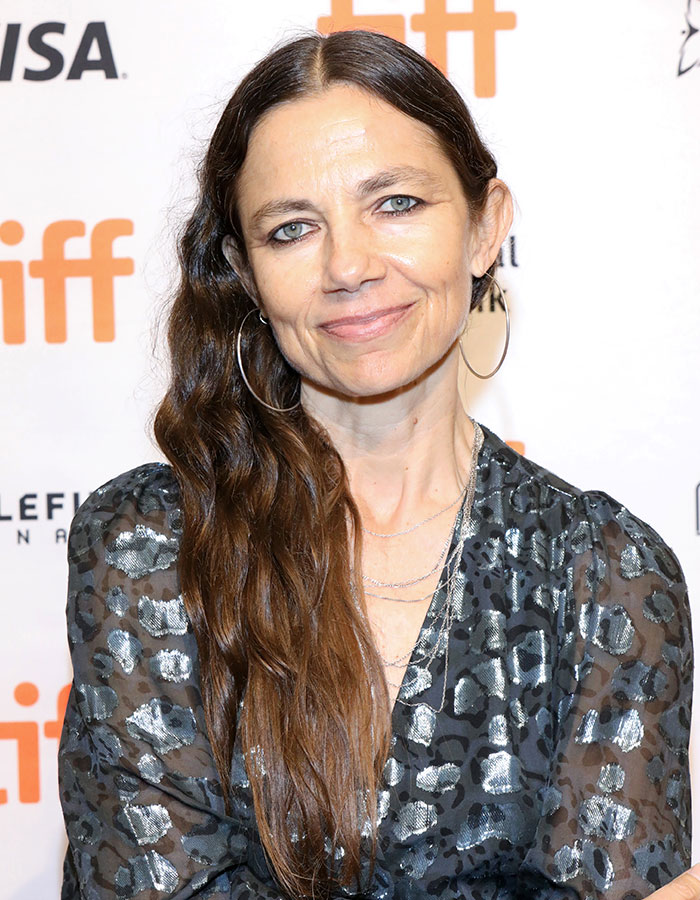 Woman with long brown hair and hoop earrings at a TIFF event, related to Jason Bateman raises eyebrows with sister Justine topic. Woman with long brown hair and hoop earrings at a TIFF event, related to Jason Bateman raises eyebrows with sister Justine topic.