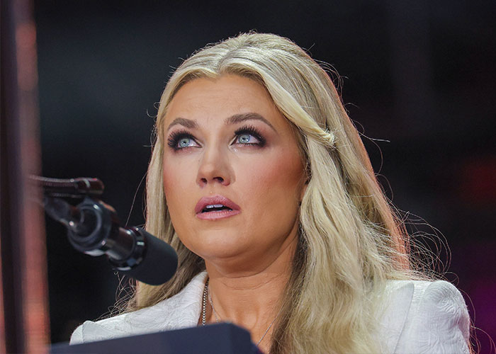 Erika Kirk speaking at a microphone during a public event, highlighted in moment with husband Charlie and body slam clip. Erika Kirk speaking at a microphone during a public event, highlighted in moment with husband Charlie and body slam clip.