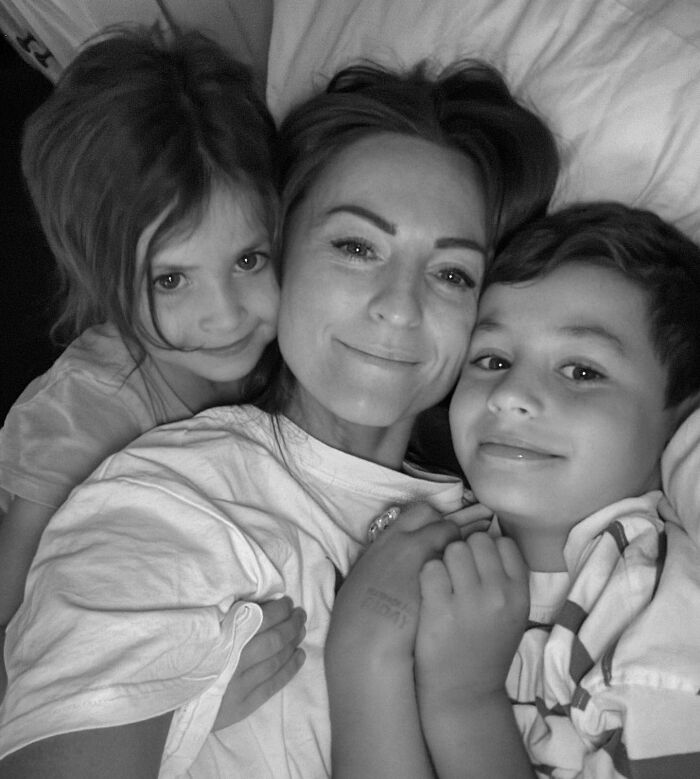 Black and white photo of an influencer with her two children, reflecting on the loss of her daughters at Christmas.